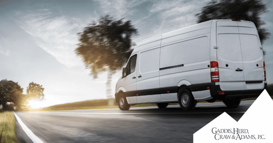 Delivery truck driving down a road