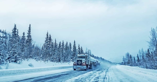 commercial truck traveling in snow