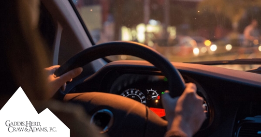 driver with both hands on the wheel