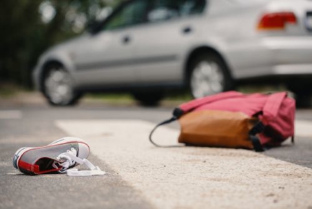 Backpack and Shoe in the Road After an Accident